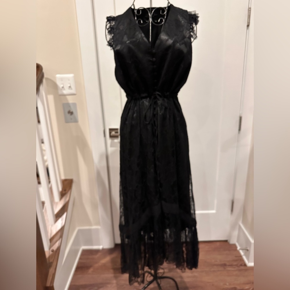 “Lace V-neck sleeveless dress with fabric buttons on the back”
